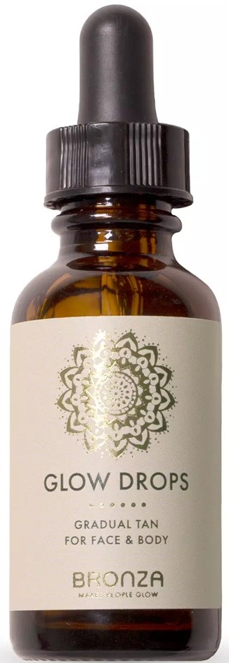 Kleine donkere fles met druppelaar, gelabeld 'Glow Drops' voor gezicht en lichaam.