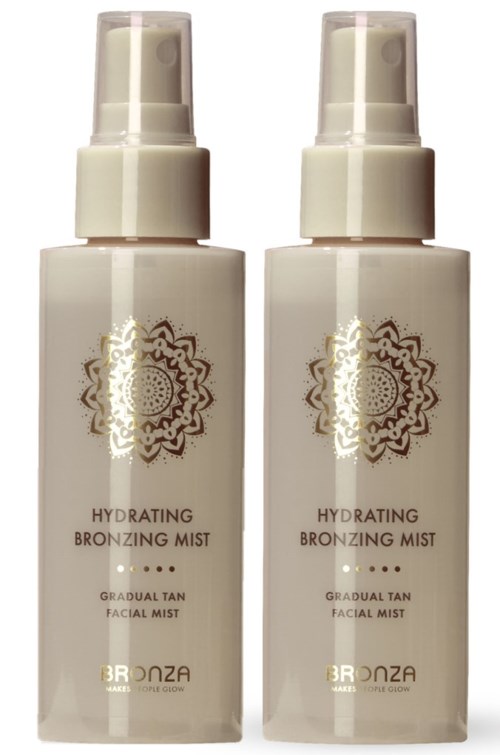 Two bottles of hydrating bronzing mist for face with a white and gold label design.