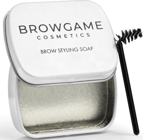 A white container labeled 'BROWNGAME COSMETICS' with a brow styling soap and a mascara wand beside it.