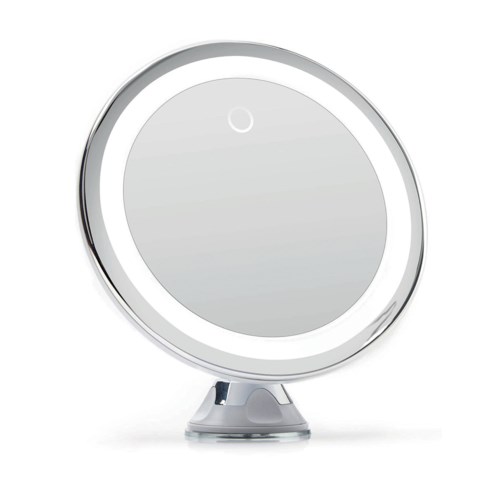 A round, mirror-like device with a light ring around the edge, sitting on a small stand.