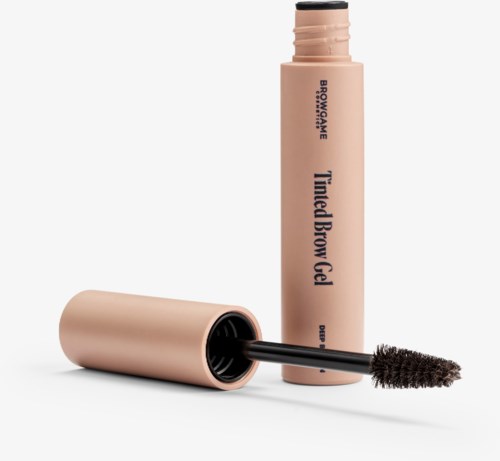 A pink tube of brow gel with its applicator brush shown separately. The label reads 'Tamed Brow Gel'.