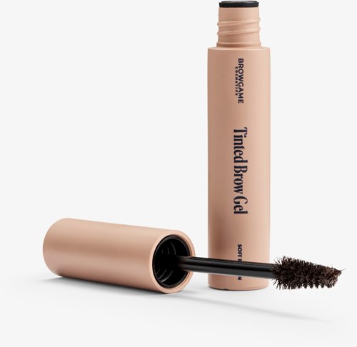 A beige tube of brow gel with a black wand and brush, labeled "Tamed Brow Gel".