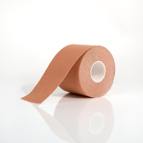 Eine Rolle braunes elastisches Klebeband mit einem herunterhängenden Ende auf einer weißen Oberfläche.