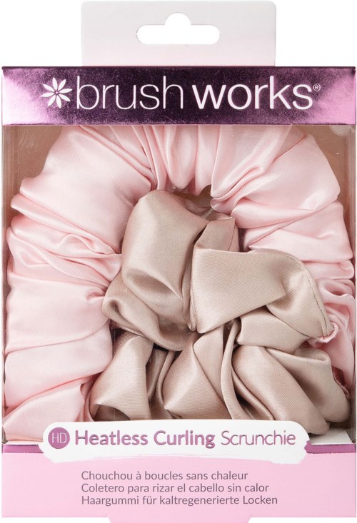A pink and beige hair scrunchie in packaging labeled 'Brush Works' and 'Heatless Curling'.