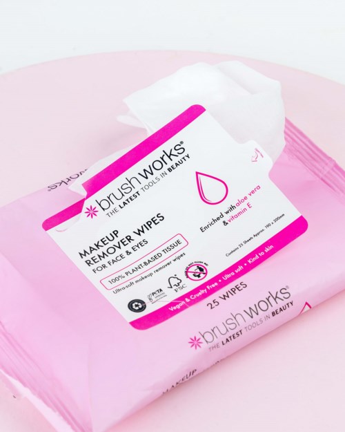 Pink package of makeup remover wipes with label and a single wipe tissue visible.