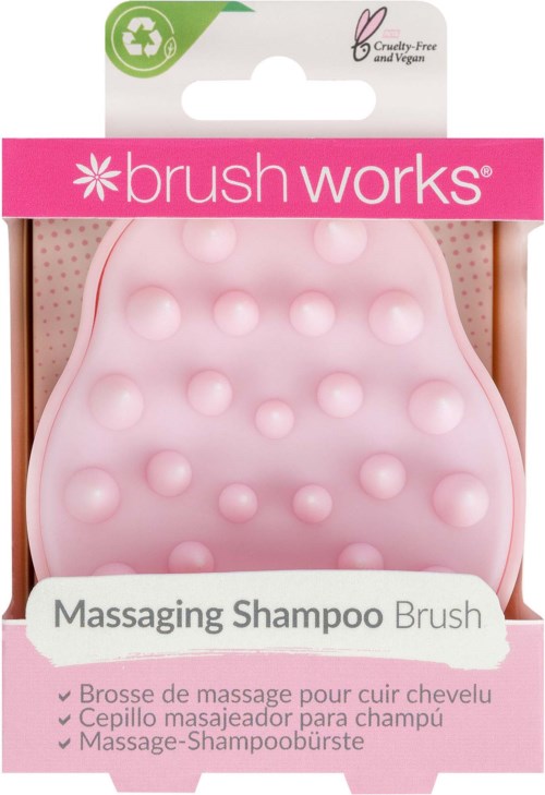 A pink oval-shaped brush with raised bumps, labeled for massaging scalp, in packaging for a cruelty-free shampoo brush.