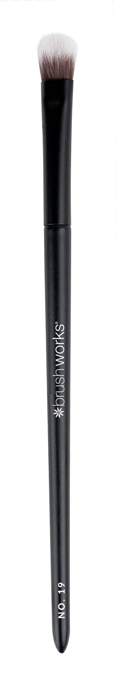 A makeup brush with a black handle and soft bristles, designed for applying eyeshadow or similar makeup.