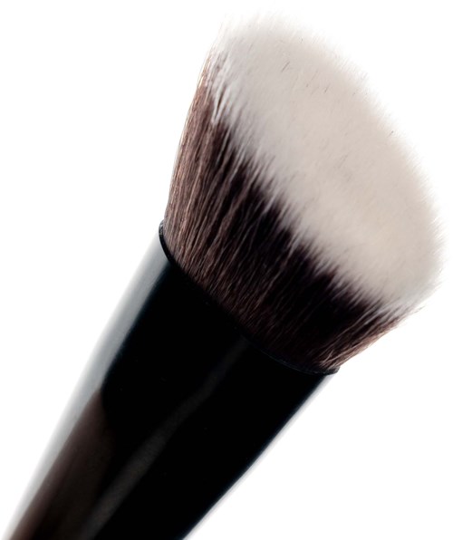 A makeup brush with black handle and soft, fluffy white bristles.