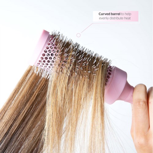 A hairbrush with a curved barrel that helps distribute heat evenly during styling.