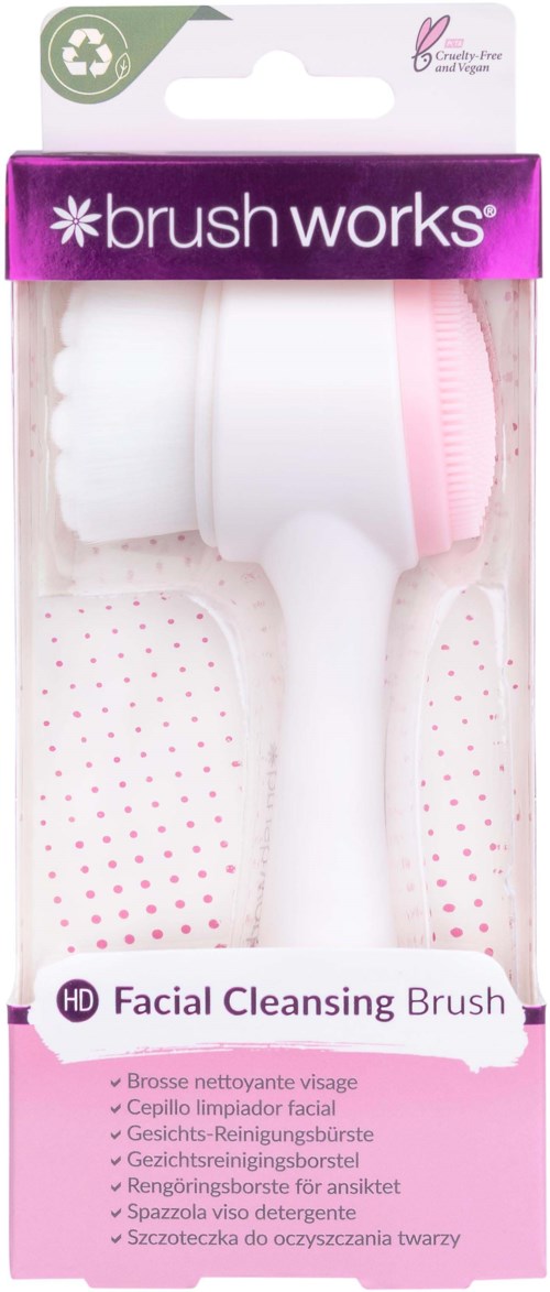 Eine weiße Gesichtsreinigungsbürste mit pinken Details in klarer Plastikverpackung, beschriftet mit "brush works."