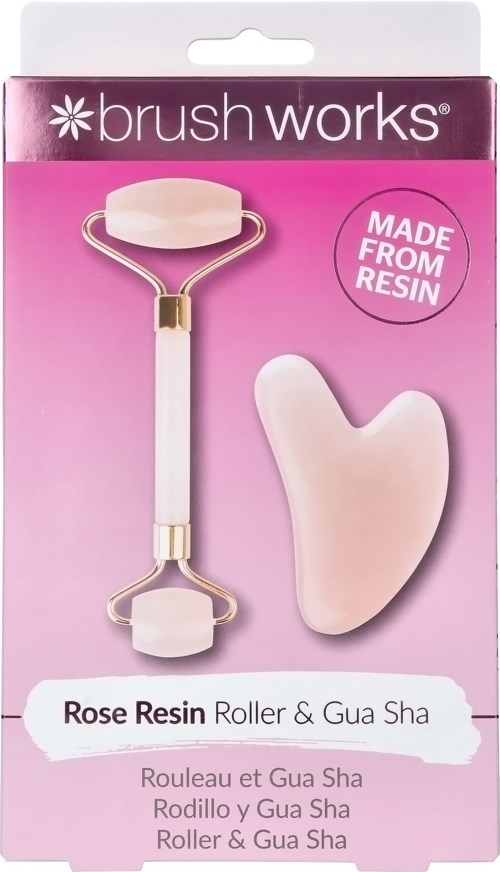 A pink box contains a face roller with a handle and a large stone, plus a smaller stone for skincare.