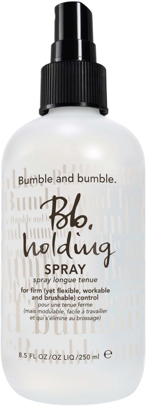 Eine weiße Sprühflasche mit schwarzem Deckel, Beschriftung "Bumble and bumble. Bb. holding SPRAY," für Haarstyling.