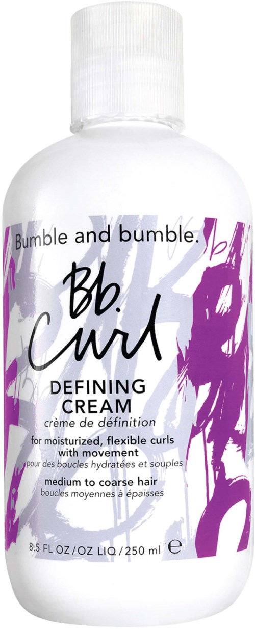 Eine weiße Flasche mit dem Label 'Bumble and bumble. Bb. Curl Defining Cream' mit lila und schwarzem Text und Kunst.
