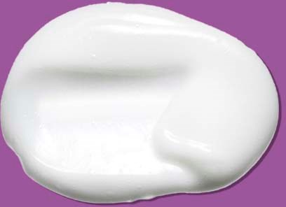 A dollop of white cream on a purple background.