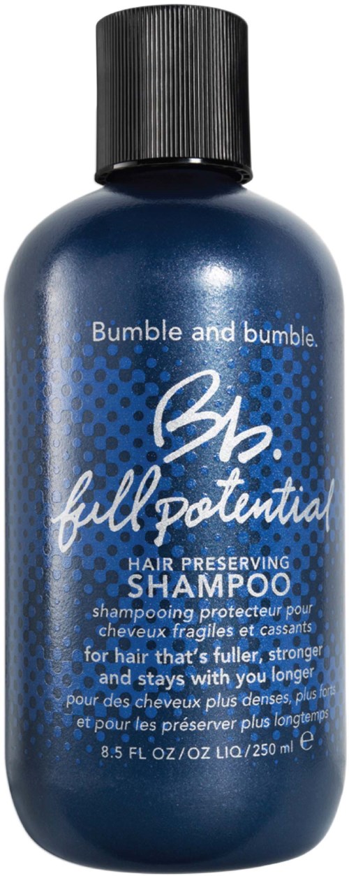 Een blauwe fles Bumble and Bumble haarshampoo, bedoeld voor haarbescherming, met zwarte dop.