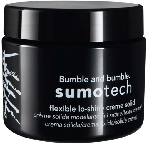 Ein schwarzer Behälter mit weißen Text, beschriftet Bumble and bumble sumotech, eine flexible Glanzcreme.