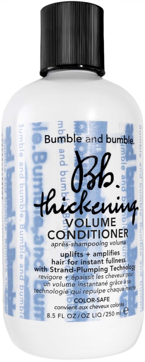 Eine weiße Flasche mit schwarzem Deckel, gekennzeichnet als Volumen-Conditioner für Haare, mit blauer und schwarzer Schrift.
