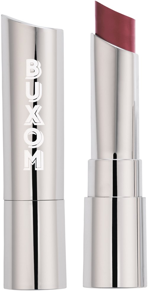 A silver lipstick tube with the word 'BUXOM' on it, and the lipstick is partially visible, showing a pink shade.