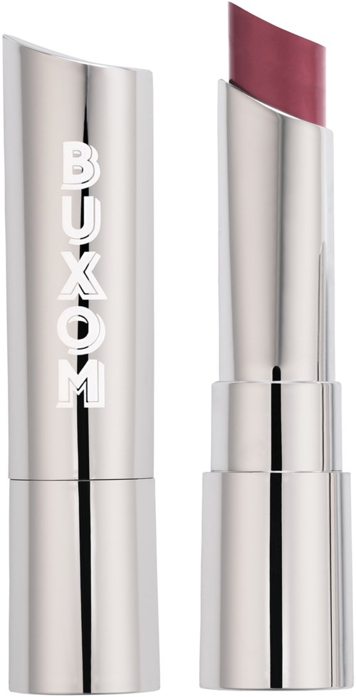 A silver lipstick case with BUXOM written on it, partially open showing pink lipstick inside.