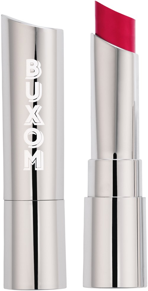A shiny silver lipstick case with the word 'BUXOM' on it, and the lipstick inside is bright pink.