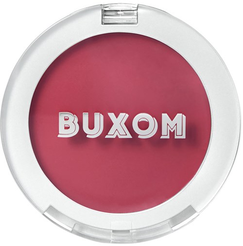 A round blush compact with the brand name 'BUXOM' in giant letters on the lid.