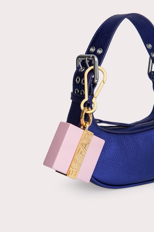 A blue bag with a pink and gold lock charm hanging from it.