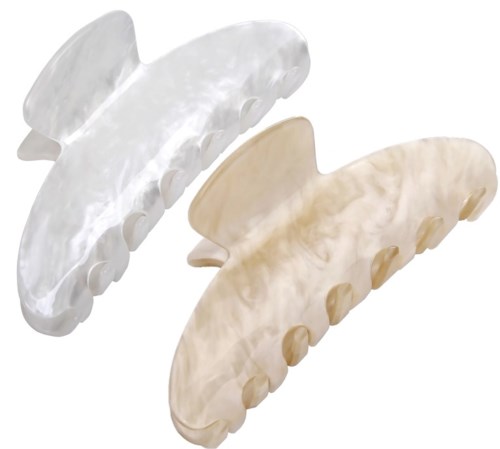 Two pearl-colored hair claws with pearl-like finishes. They are curved and have teeth for gripping hair.