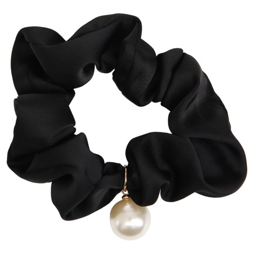 A black scrunchie with a large pearl charm hanging from it.