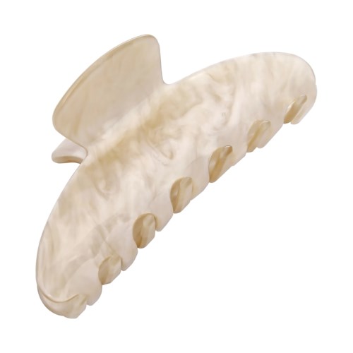A cream-colored hair clip shaped like a dolphin with small fins and a smiling face.