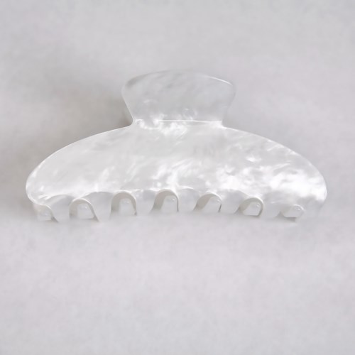 A clear, plastic hair claw clip with multiple teeth and a curved top.