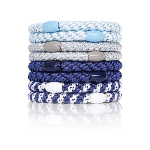Stacked colorful friendship bracelets with braided and beaded designs.