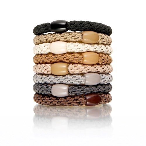 Stack of nine woven bracelets in black, brown, white, beige, gray, and dark brown with large beads.