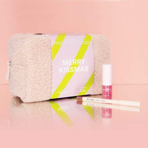 Een zacht cadeau met kerstgroet, lippenbalsem en lippenstift ernaast.