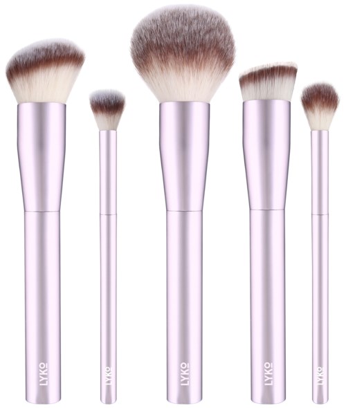 Set of five makeup brushes with pink handles and fluffy white bristles in different sizes.