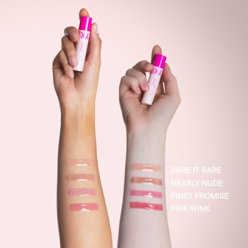 Close-up of lips with shiny pink lip gloss on a smooth skin face.