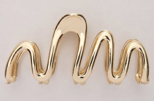 A shiny, gold-colored, wavy object with a smooth surface and rounded ends.
