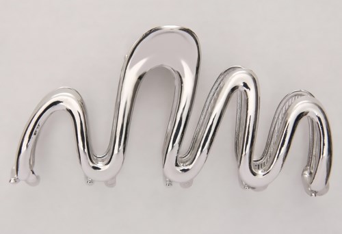 A metallic, shiny zigzag-shaped object, possibly a decorative piece or sculpture, against a plain background.