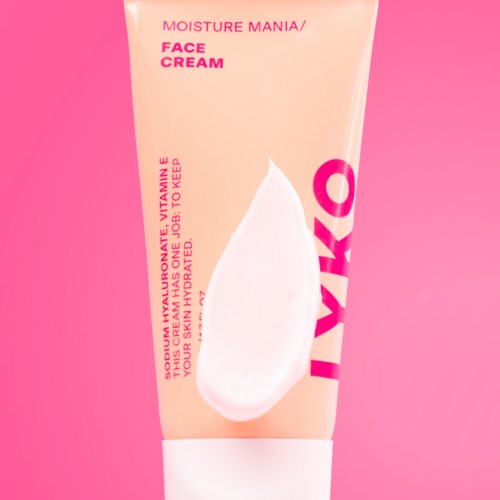 Een roze tube met MOISTURE MANIA FACE CREAM en een witte crème afbeelding op de voorkant.