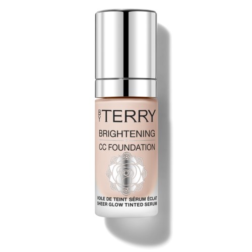 A small beige bottle with a silver cap labeled 'BY TERRY Brightening CC Foundation' and a rose design.