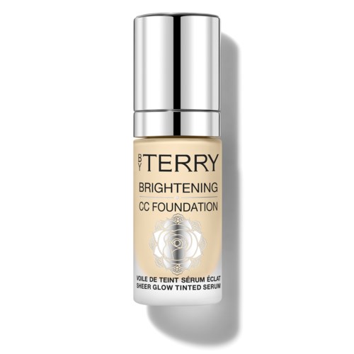 A bottle of brightening CC foundation with a silver cap and a white label featuring a gold rose design.