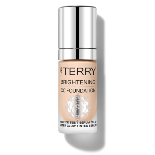 A bottle of brightening CC foundation with a silver cap and a beige label showing a rose design.