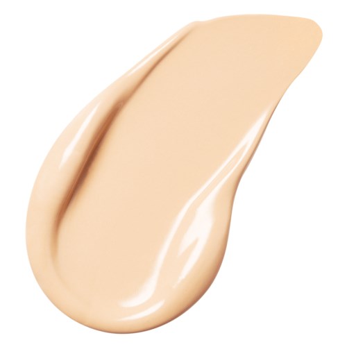 A beige-colored cream with a smooth and creamy texture, shaped like a teardrop.