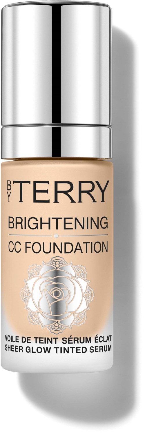 A bottle of beige liquid foundation with silver cap, labeled 'BY TERRY Brightening CC Foundation,' featuring a rose and lock design.