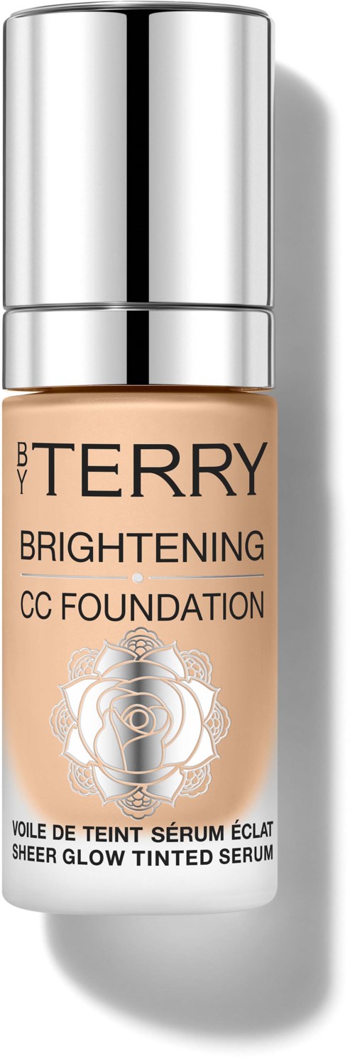 A beige bottle with a silver cap, labeled 'By Terry Brightening CC Foundation' and decorative design.