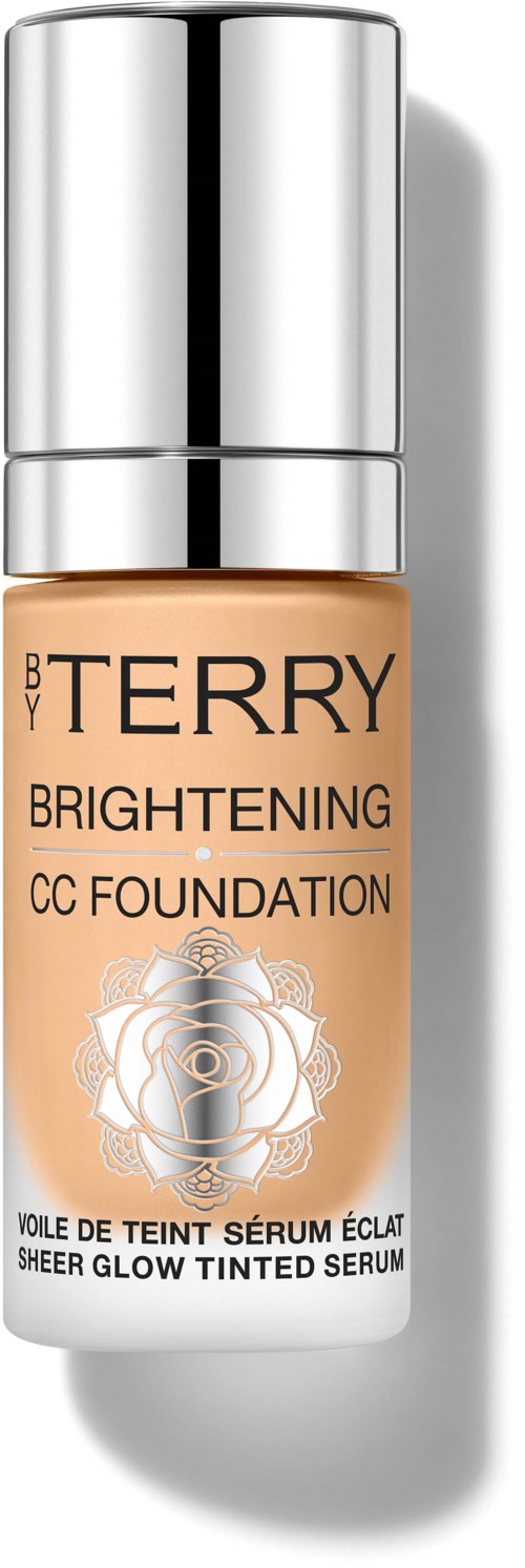 A bottle of BB By Terry Brightening CC Foundation with a silver cap and a rose design on the label.