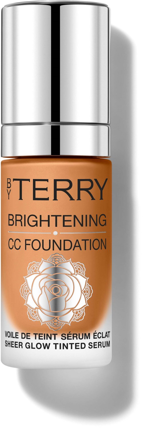 A bottle of BY TERRY Brightening CC Foundation with a silver cap and white and orange label.