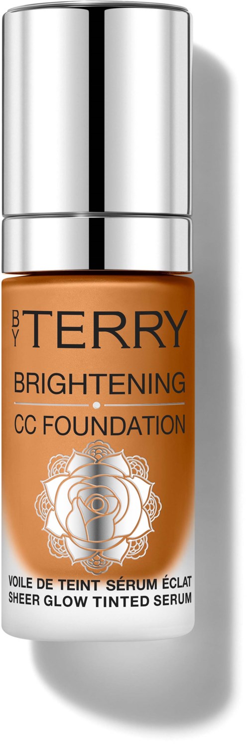 A small bottle of BY TERRY Brightening CC Foundation with a silver cap and orange liquid inside.