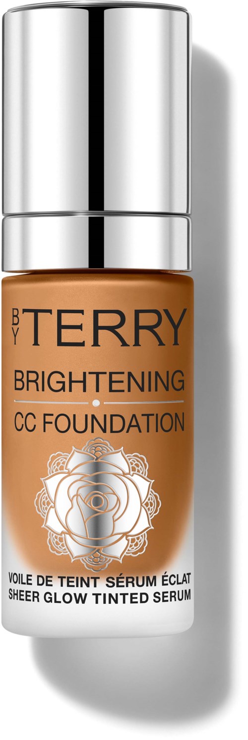 A bottle of Bobbi Brown Brightening CC Foundation with a silver cap and a label showing a rose design.