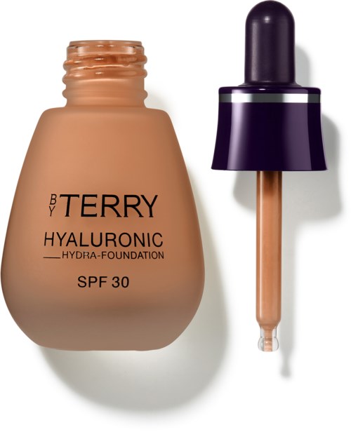 Beige meikkapullo tiputteella, merkinnällä 'BY TERRY Hyaluronic SPF 30'.