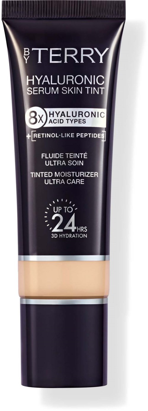 Tub med By Terry Hyaluronic Serum Skin Tint i svart och beige förpackning, visar hudvårdsfördelar och ibruk av fukt i upp till 24 timmar.
